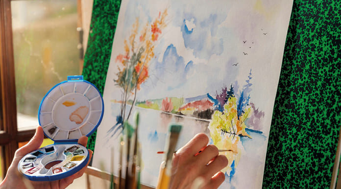 Aglutinantes y disolventes Artista pintando un cuadro con paleta de colores como metáfora de la diversidad y cohesión en los grupos humanos